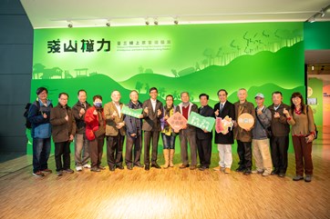 Attendees posing in front of the “Treasure of Mountains Tracing the Camphor Industry in Indigenous and Hakka Settlements along Route 3” exhibition site